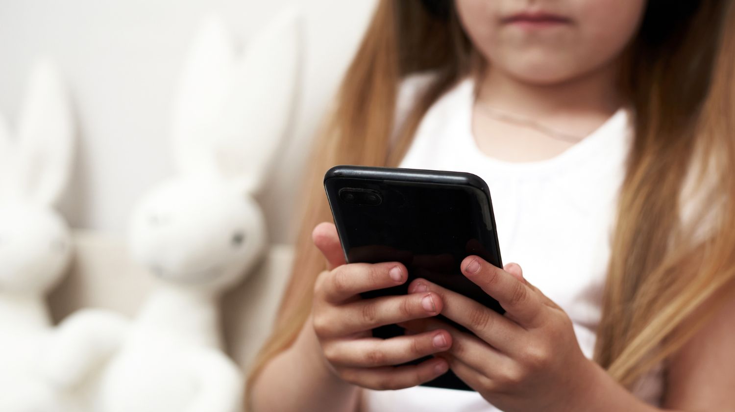 Devojčica drži telefon u ruci